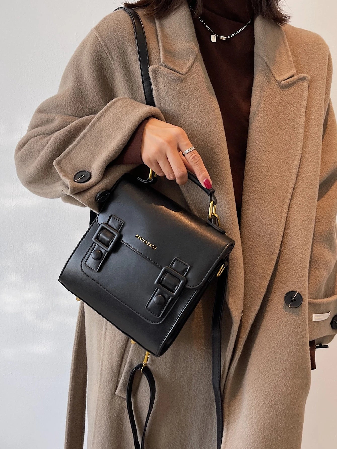 Mochila retro negra para mujer detalle del asa superior y hebillas