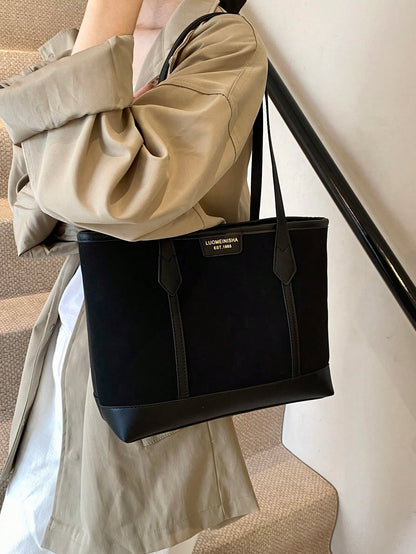 Bolso tote negro para mujer llevado al hombro con doble asa