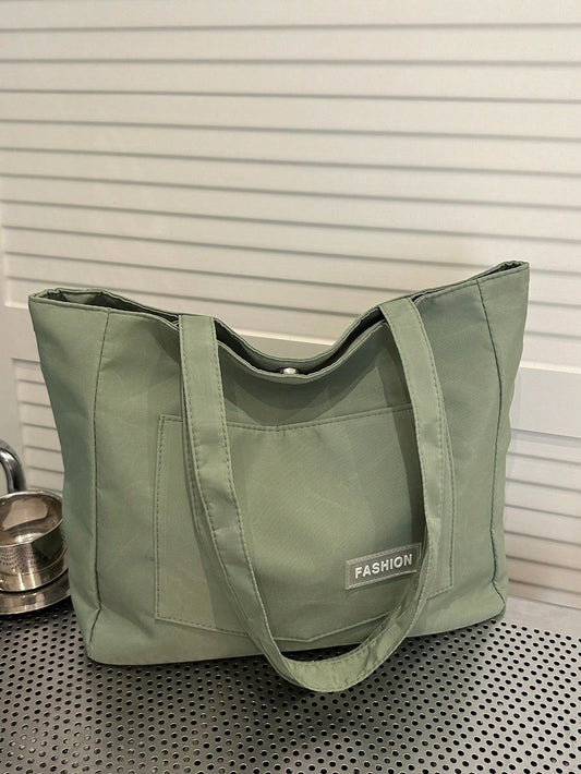 bolso tote verde para mujer vista frontal con bolsillo frontal