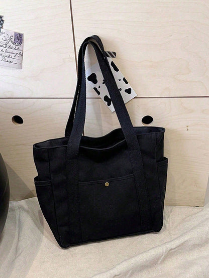 bolso tote negro para dama en uso con maleta